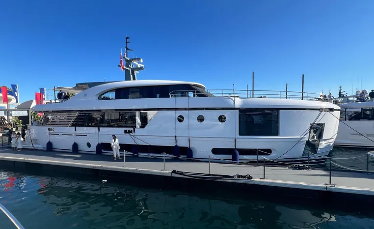 Azimut Magellano 30M 2024 luxury yacht docked at marina under clear blue sky.
