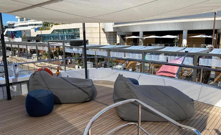 Deck of 2024 Azimut Magellano 30M yacht with bean bags and canopy.