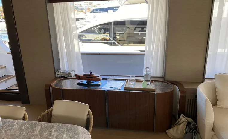 Luxurious interior of 2024 Azimut Magellano 30M yacht with elegant furnishings and large windows.