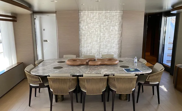 Luxurious dining area on 2024 Azimut Magellano 30M yacht with elegant table and chairs.
