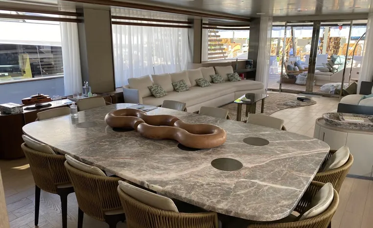 Luxurious interior of 2024 Azimut Magellano 30M yacht with elegant dining and seating areas.