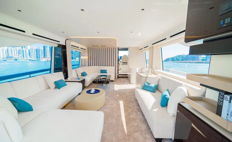Luxurious interior of 2025 Azimut Fly 78 yacht with panoramic windows and elegant seating.