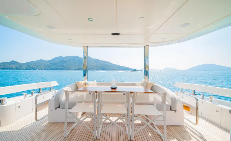 Luxurious Azimut Fly 78 yacht deck with stunning ocean and mountain views, 2025 model.