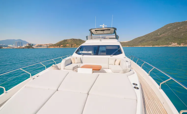 Luxury 2025 Azimut Fly 78 yacht cruising on clear blue ocean waters.