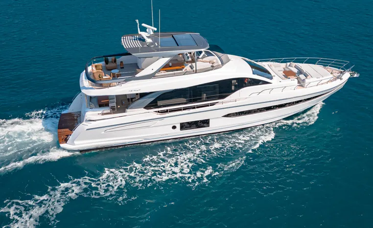 Luxury 2025 Azimut Fly 78 yacht cruising on clear blue ocean waters.
