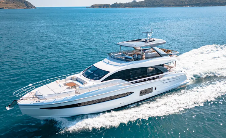 Luxury 2025 Azimut Fly 78 yacht cruising on open sea, surrounded by scenic islands.
